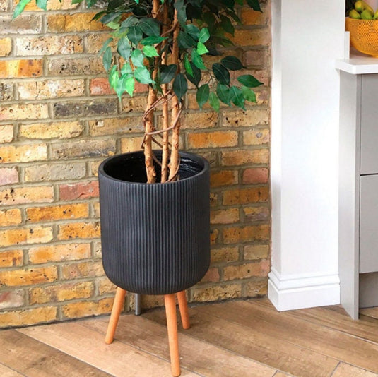 Black Round Cylinder Ribbed Concrete and Stone Indoor Tripod Pot Planter stand On Wooden legs Modern Interior Decor for faux or real plants